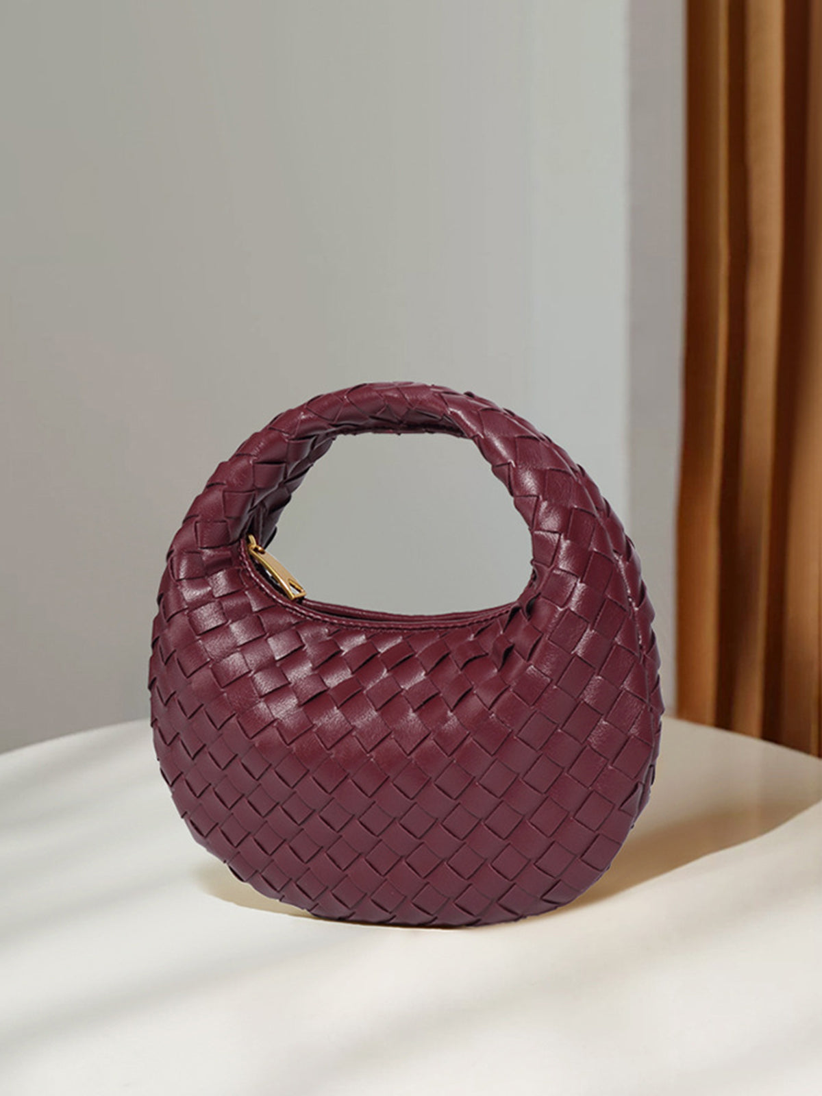 Petit sac à main zippé en tissu arrondi